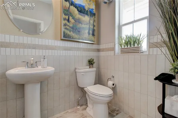 a bathroom with a sink a mirror and a toilet