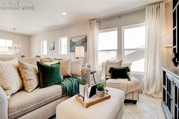 a living room with furniture fireplace and a large window
