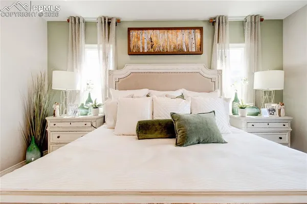 a bedroom with a bed and a large mirror