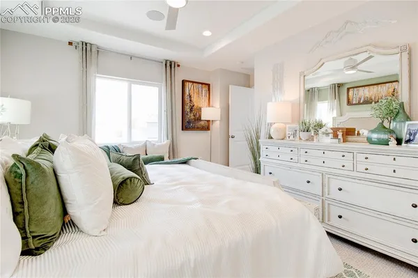 a spacious bedroom with a bed and window