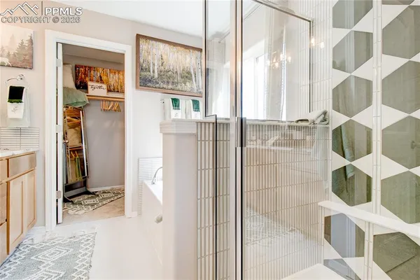 a bathroom with a glass shower door