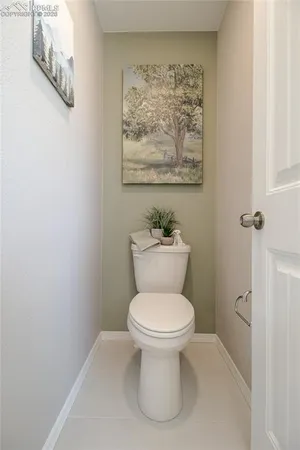 a white toilet sitting next to a bathroom sink