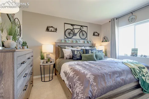 a bedroom with a bed and a dresser in it