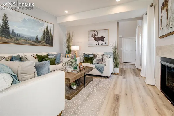 a living room with furniture and a fireplace