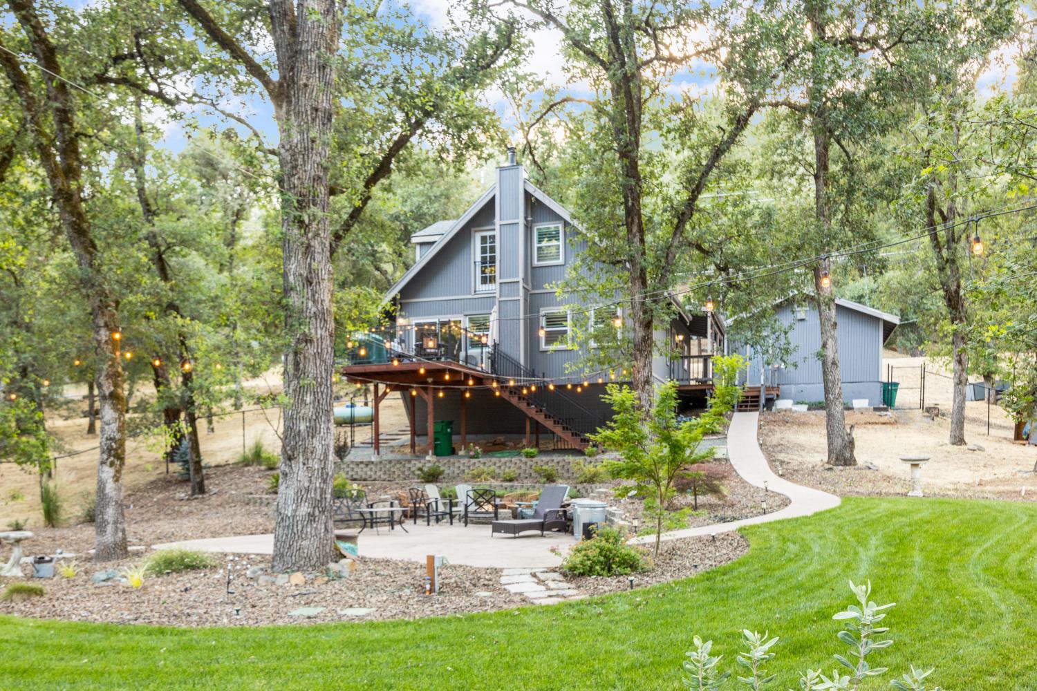 16927 Brewer Road Grass Valley, CA 95949 - Photo 1 of 1 a front view of a house with garden and trees
