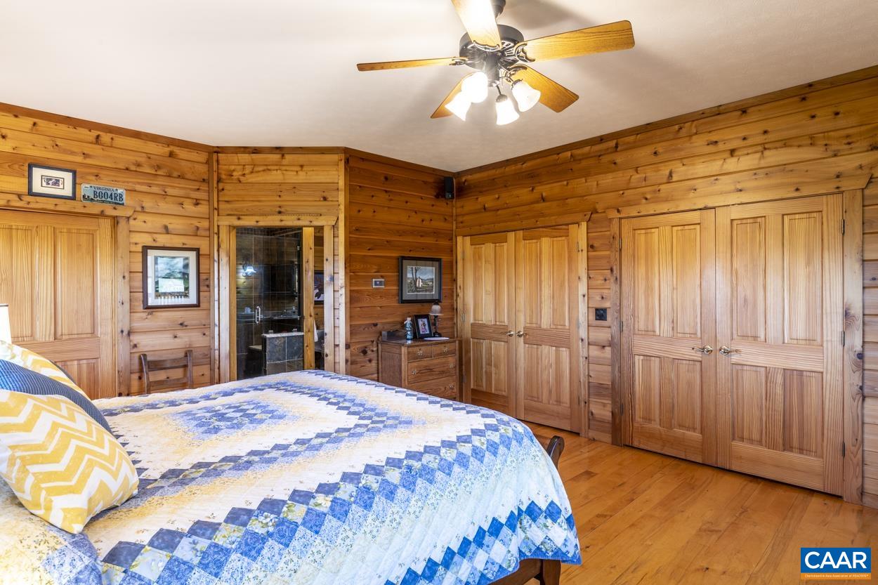 556 Good Hope Church Road Aroda, VA 22709 - Photo 54 of 75 a bedroom with a bed and a chandelier