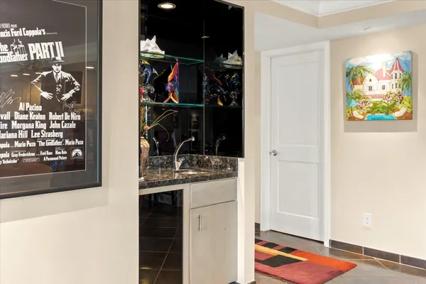 a living room with furniture a wooden floor and a large window