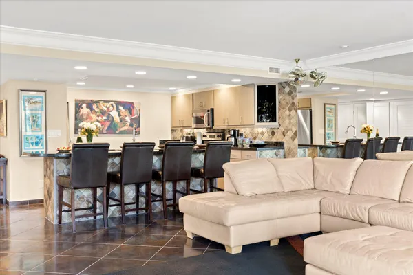 a living room with furniture tv and a flat screen tv