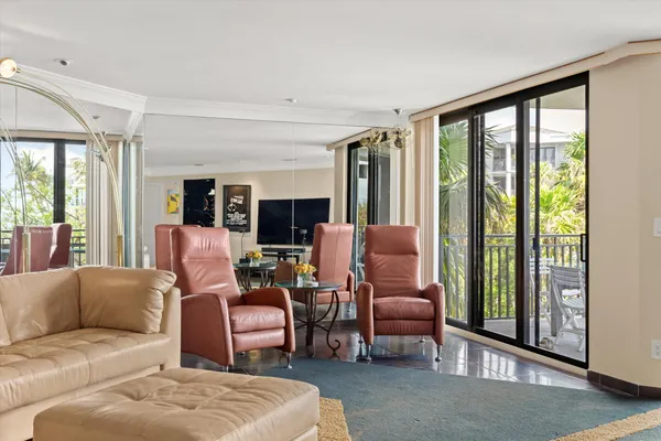 a view of a hallway with wooden floor and windows