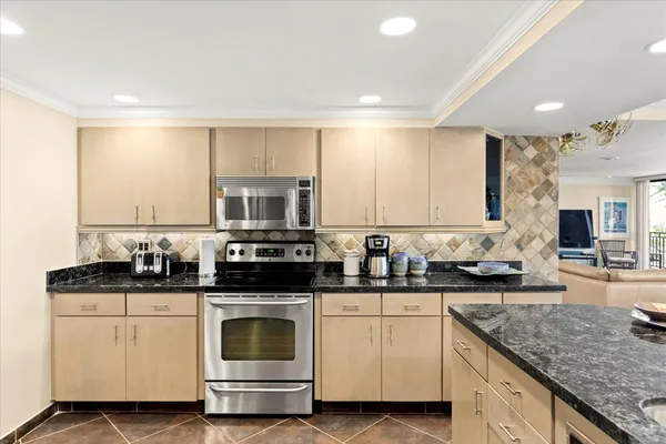 a living room with furniture large windows and flat screen tv