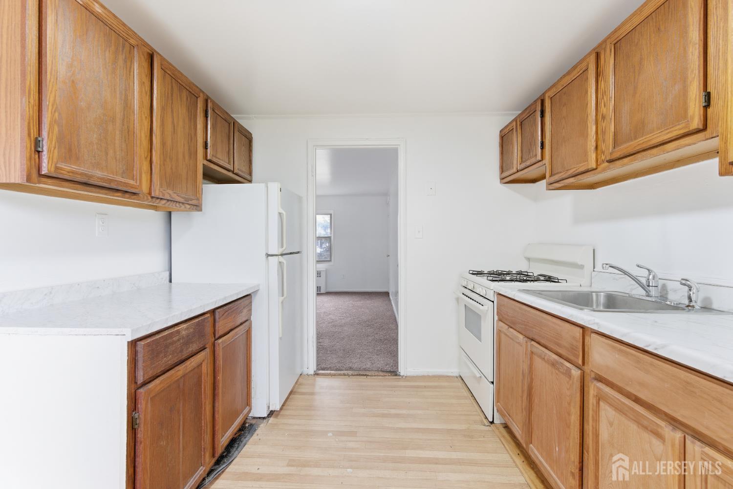 37B Garfield Park, Unit B Edison, NJ 08837 - Photo 11 of 18 a kitchen with stainless steel appliances granite countertop a sink stove and refrigerator
