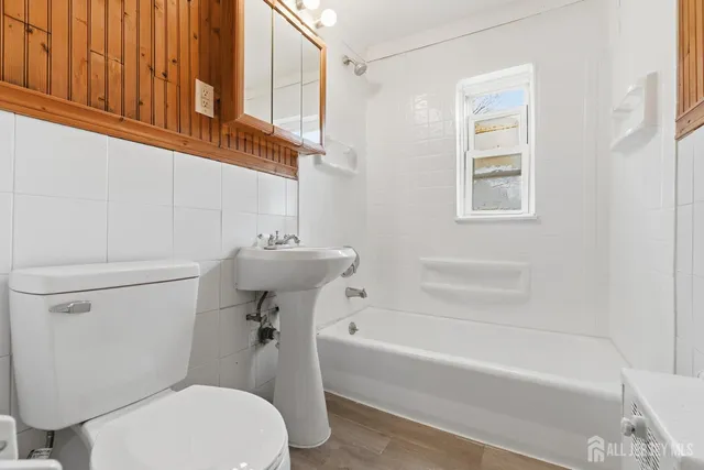 a bathroom with a sink a toilet and bathtub