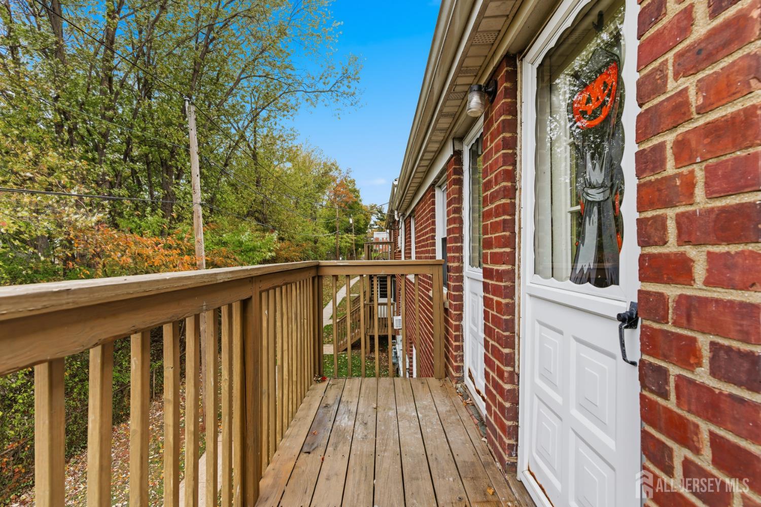 37B Garfield Park, Unit B Edison, NJ 08837 - Photo 16 of 18 a view of a balcony with wooden floor and fence