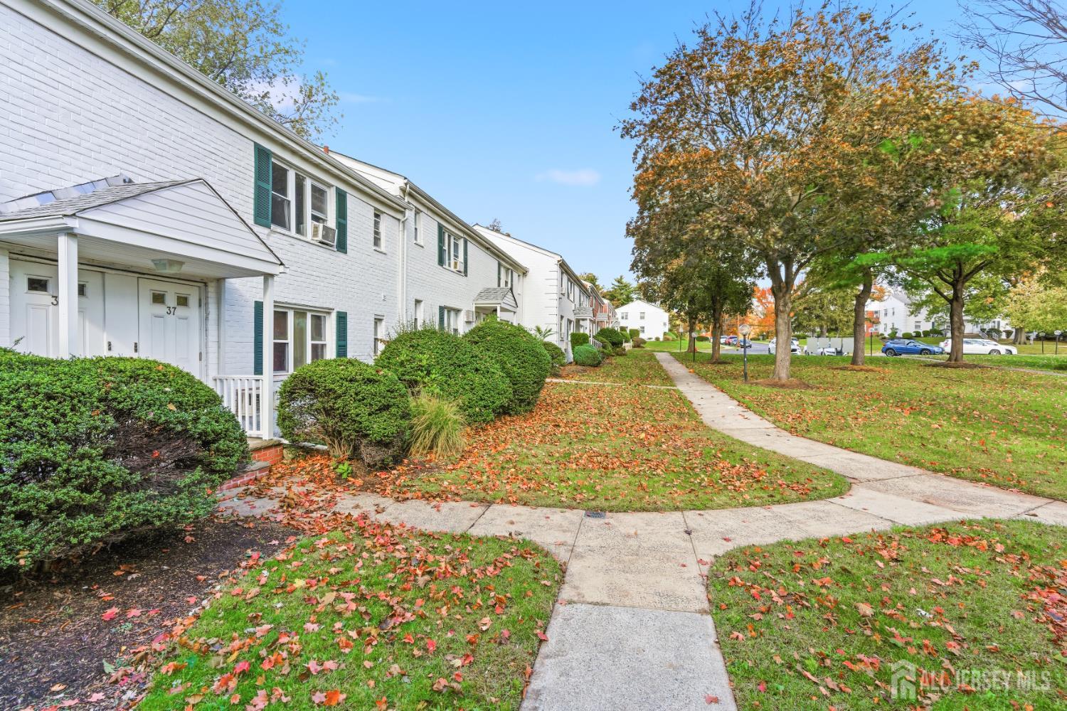 37B Garfield Park, Unit B Edison, NJ 08837 - Photo 2 of 18 a view of a white house with a yard and potted plants
