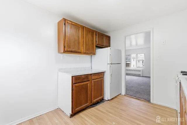 a view of a kitchen with a sink cabinets and a refrigerator