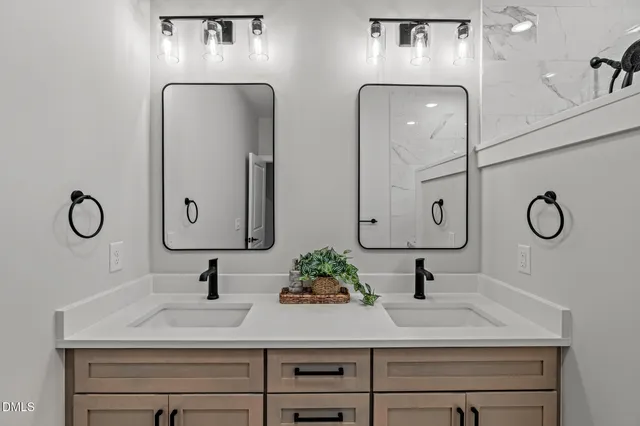 a bathroom with double vanity sink and mirror