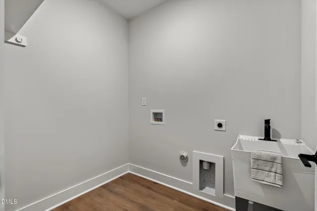 a view of storage and utility room with wooden floor