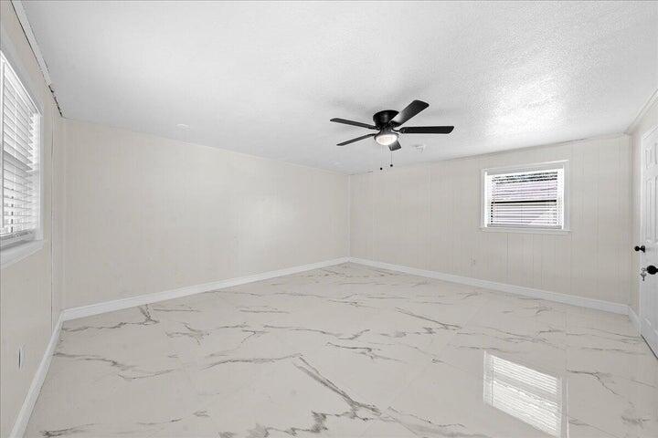 3401 Purdue Street Melbourne, FL 32901 - Photo 15 of 19 an empty room with a window and a ceiling fan
