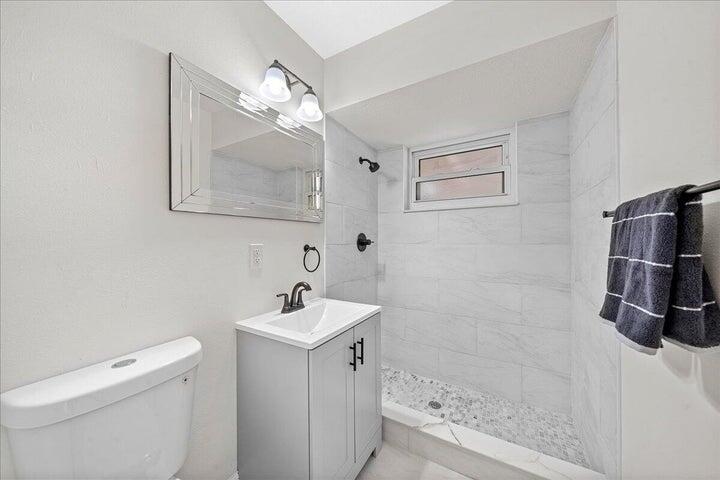 3401 Purdue Street Melbourne, FL 32901 - Photo 16 of 19 a bathroom with a sink a toilet and shower