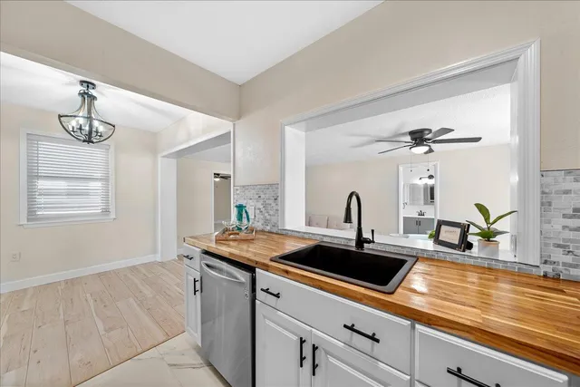 a kitchen with a sink and a mirror
