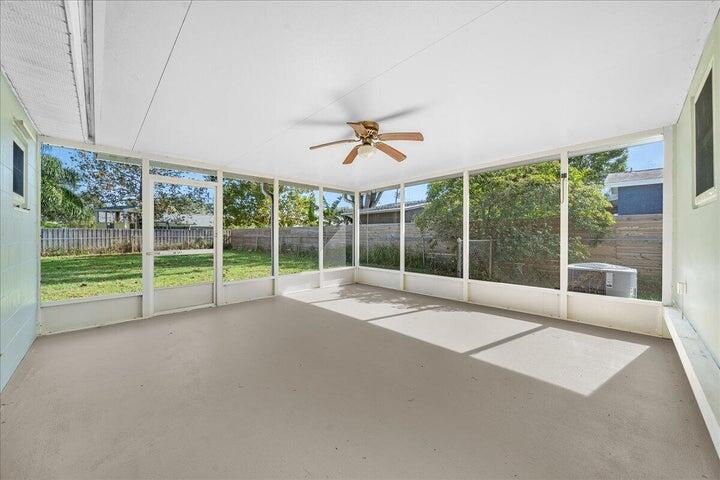 3401 Purdue Street Melbourne, FL 32901 - Photo 10 of 19 a view of an empty room with a floor to ceiling windows and a ceiling fan