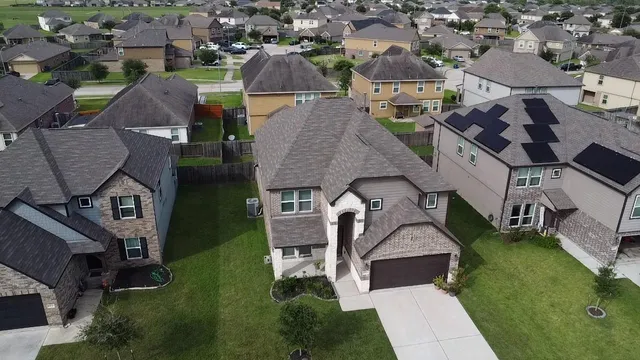 an aerial view of a house with garden space and street view