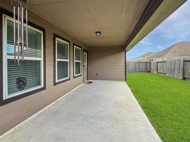 a view of a house with a yard and pathway
