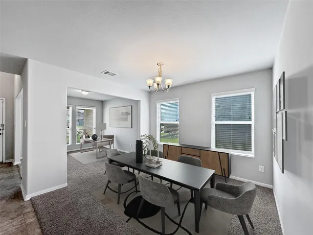 a view of a dining room with furniture and window