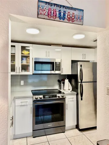 a kitchen with stainless steel appliances a refrigerator sink and stove