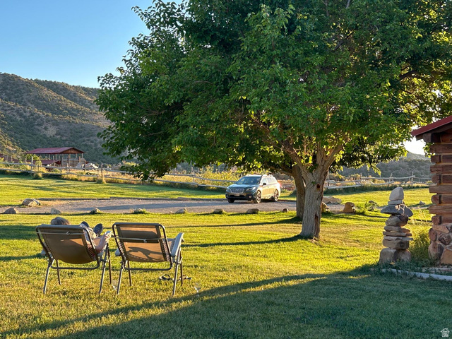 315 Abbey Road Moab, UT 84532 - Photo 6 of 46 View of grassy yard featuring a mountain view