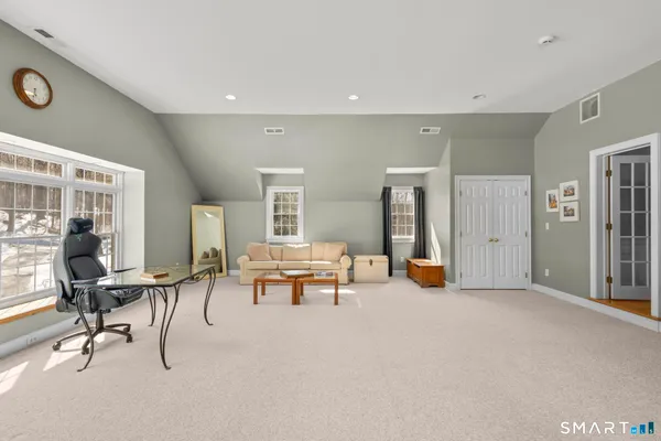 a view of a livingroom with furniture and a window