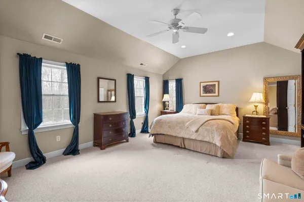 a spacious bedroom with a large bed and a couch