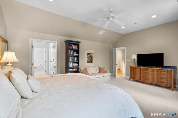 a bedroom with a bed and a flat screen television
