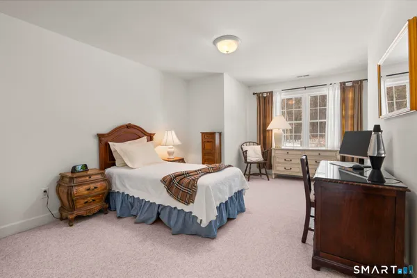 a spacious bedroom with a bed and a couch
