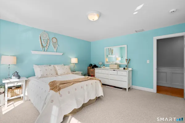 a spacious bedroom with a bed and ceiling fan