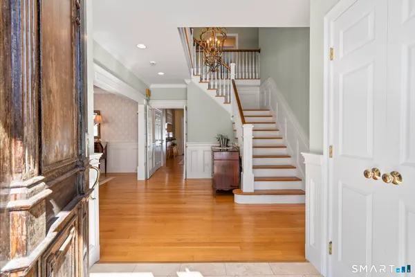 a view of entryway and hall with wooden floor