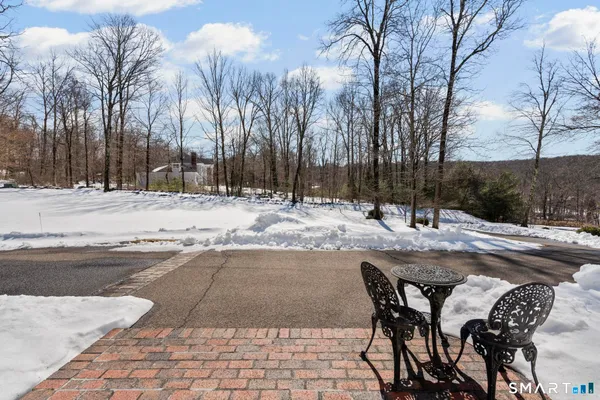 a view of a backyard with snow on the patio