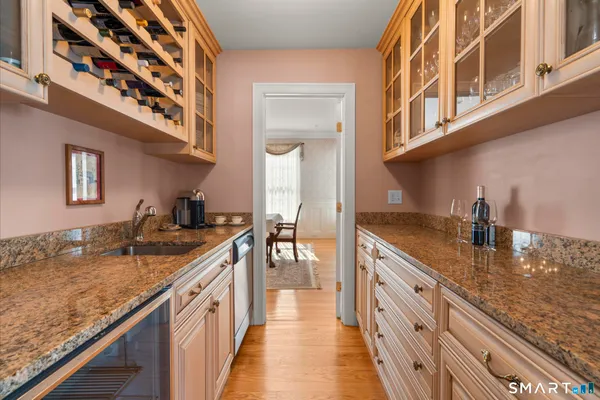 a kitchen with granite countertop a sink and cabinets