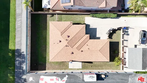 an aerial view of a house with a yard