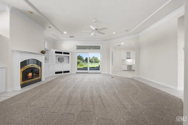a view of a big room with chandelier and windows