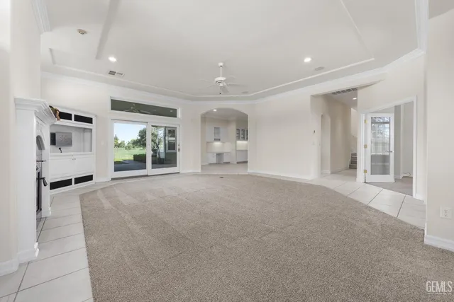 a view of a livingroom with furniture fire place and windows