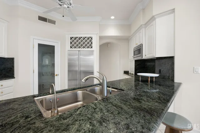 a large kitchen with cabinets and steel stainless steel appliances