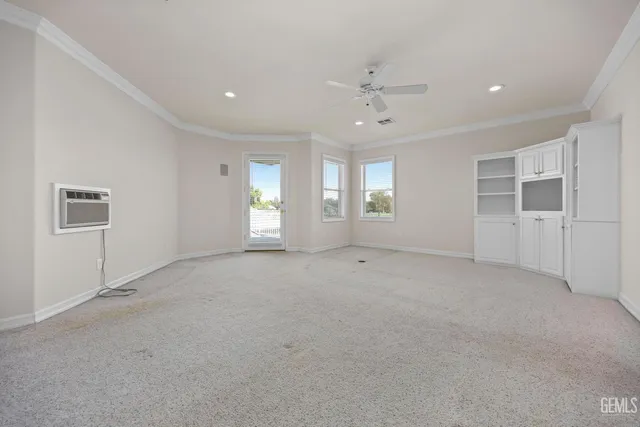 an empty room with closet and windows