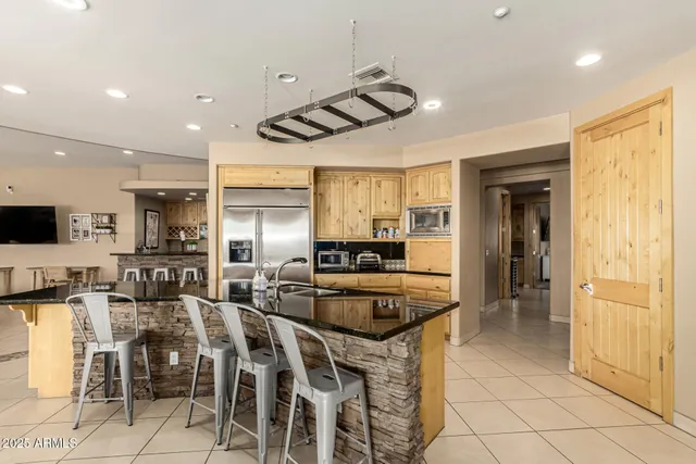 a kitchen with lots of counter top space and stainless steel appliances