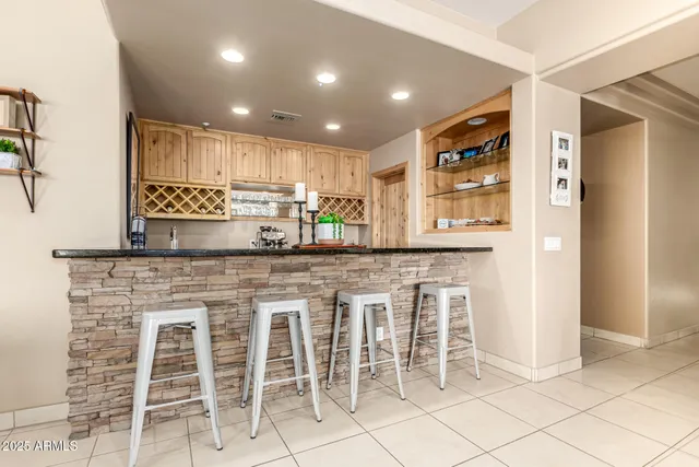 a kitchen with a dining table chairs cabinets and stainless steel appliances