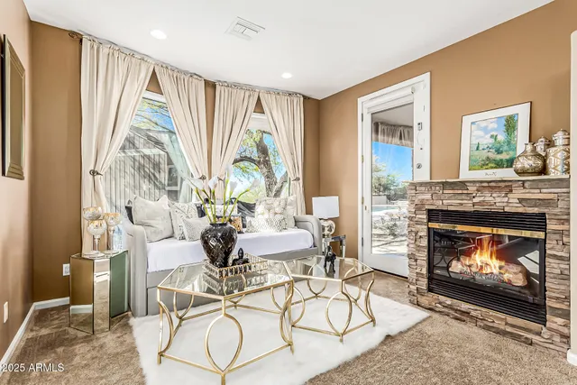 a living room with furniture and a fireplace