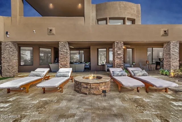 a living room with patio furniture and a potted plant