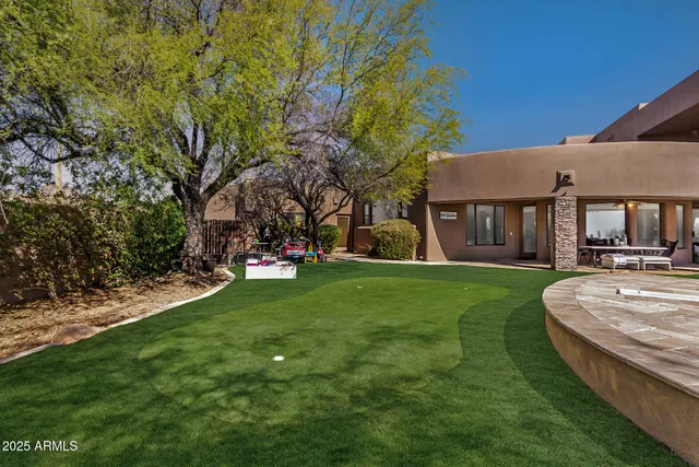 an aerial view of a house with swimming pool and lake view