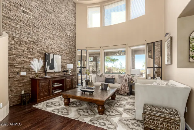 a living room with furniture a rug and a table