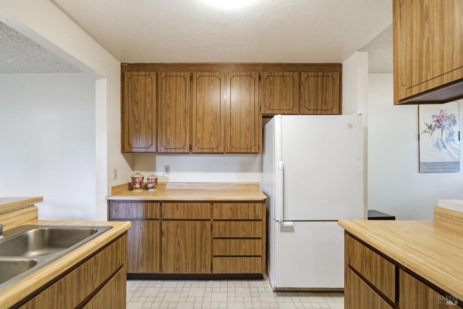 514 Racquet Club Circle Rohnert Park, CA 94928 - Photo 11 of 39 a kitchen with a sink a refrigerator and cabinets